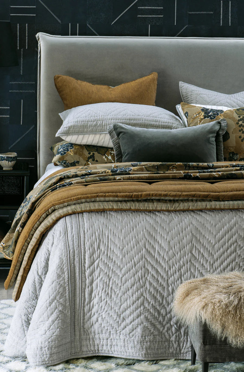 Japanese-inspired grey bedspread draped to the floor