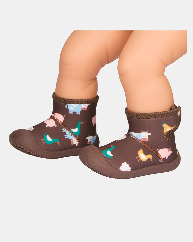 Children's brown boots with animal pattern on a white background