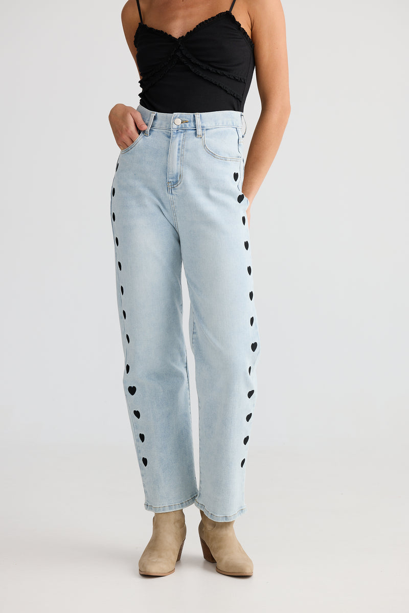 Women’s straight leg jeans with natural waist and silver hardware
