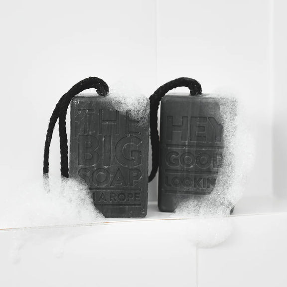 Two black soap bars on a white background with text.