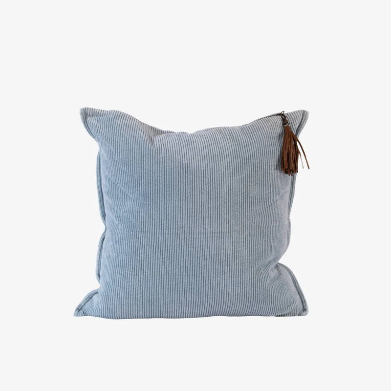 Soft blue cotton corduroy cushion with ribbed texture and removable handmade leather tassel.