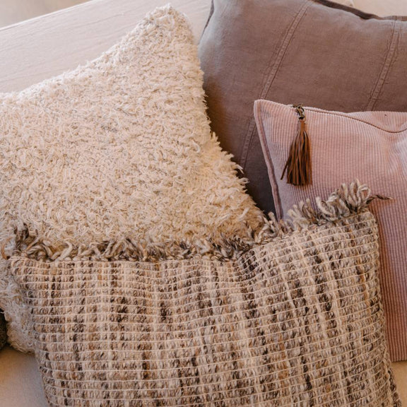 Rectangular Soft Musk pink corduroy cushion with removable handmade leather tassel.