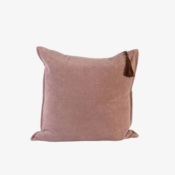 Soft musk pink corduroy cushion with ribbed cotton texture and removable handmade leather tassel.
