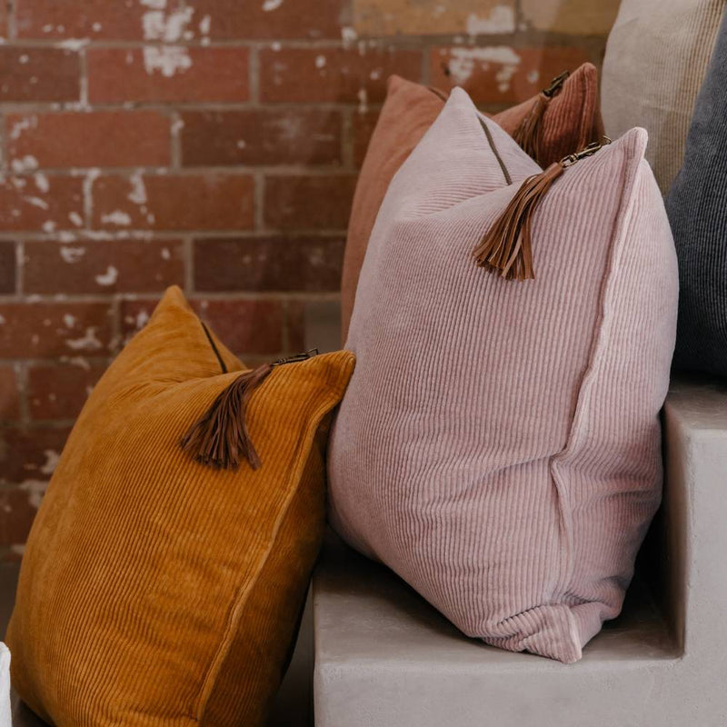 Textured cotton corduroy cushion in soft musk pink with wide rib design and handcrafted finish.