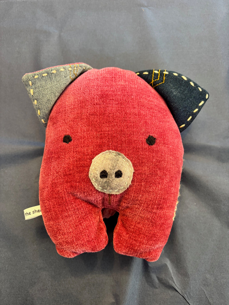 Eco-friendly plush pig toy sitting upright