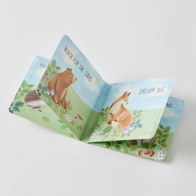 Open children's book with animal illustrations on a light gray background