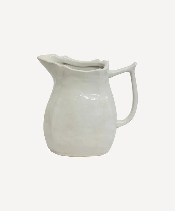 Small off-white pitcher with classic curved handle