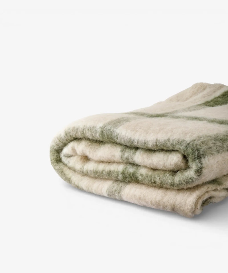 Juniper fringed check throw styled across a sofa or armchair.