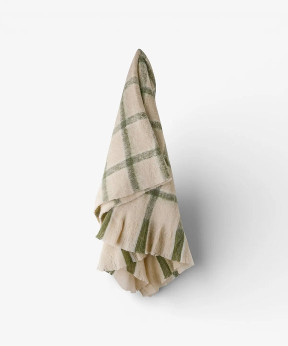 Classic green check throw with neutral background and decorative fringe.