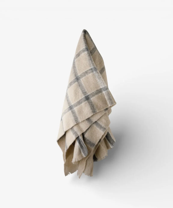 Classic grey check throw with neutral background and decorative fringe.