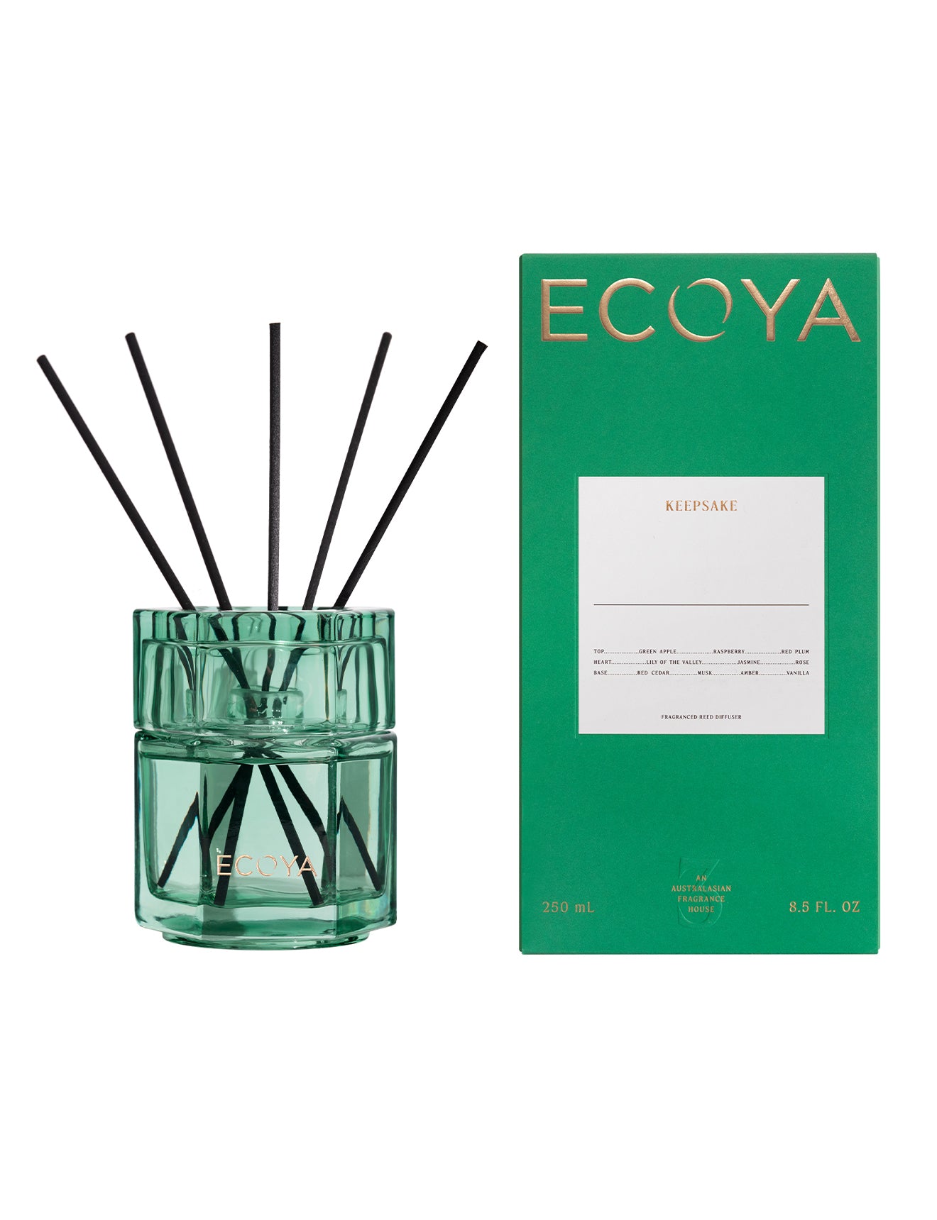 Green diffuser with black sticks and matching green box on a white background