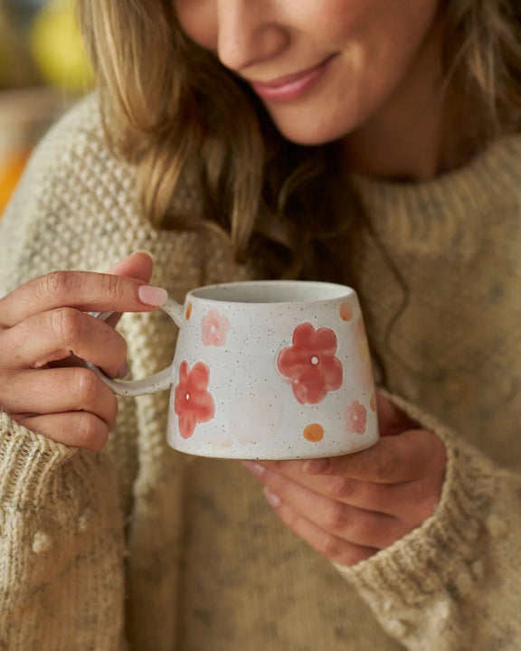 Large handled stoneware coffee mug with hand-painted flowers and decorative glazed finish.