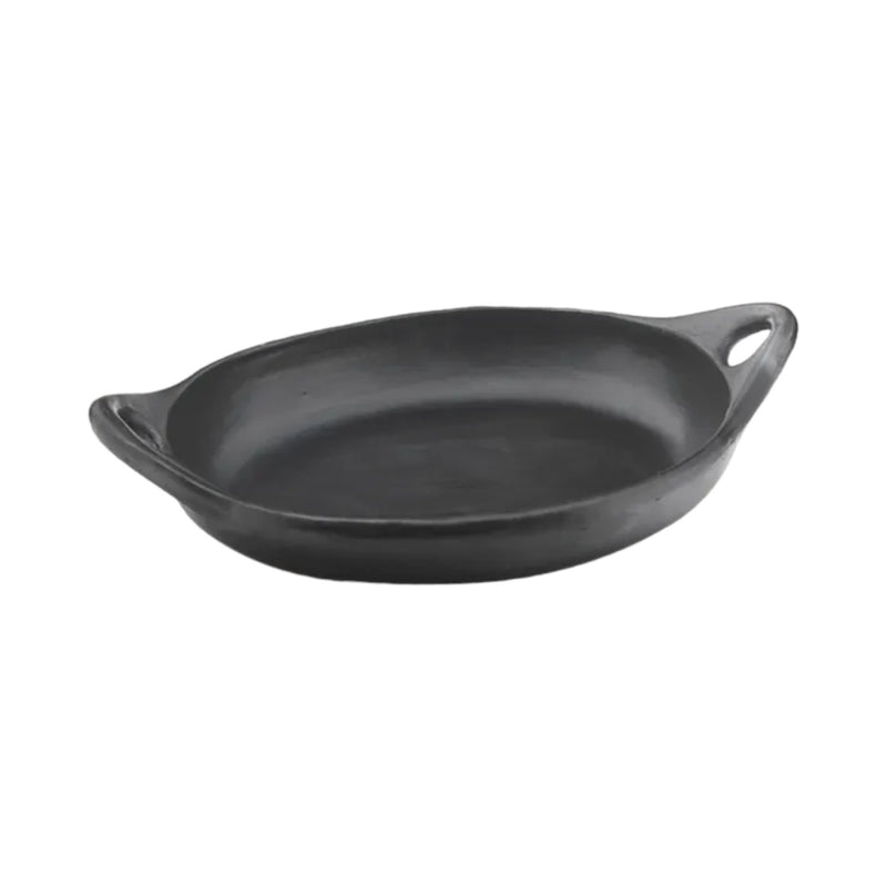 Black La Chamba oval clay dish with handles handcrafted in Colombia for cooking and serving.
