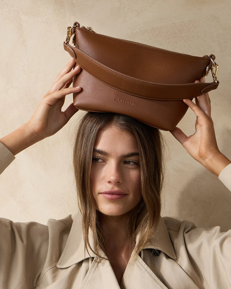 Tan Saffiano Elms+King Leyton crossbody bag with gold hardware.