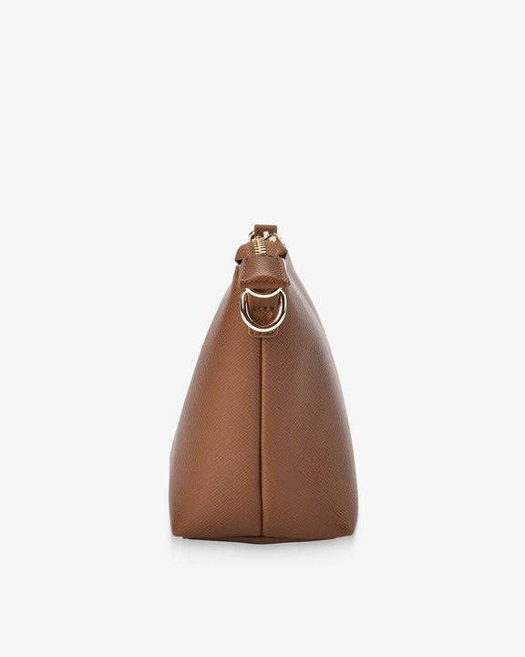 Brown leather handbag with gold ring on a white background