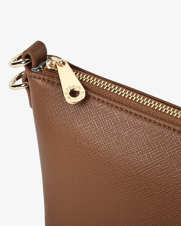 Brown leather clutch with gold zipper and clasp on a white background