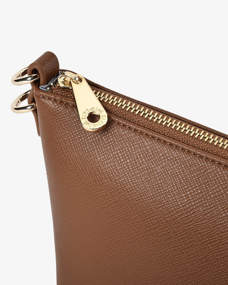 Brown leather clutch with gold zipper and clasp on a white background