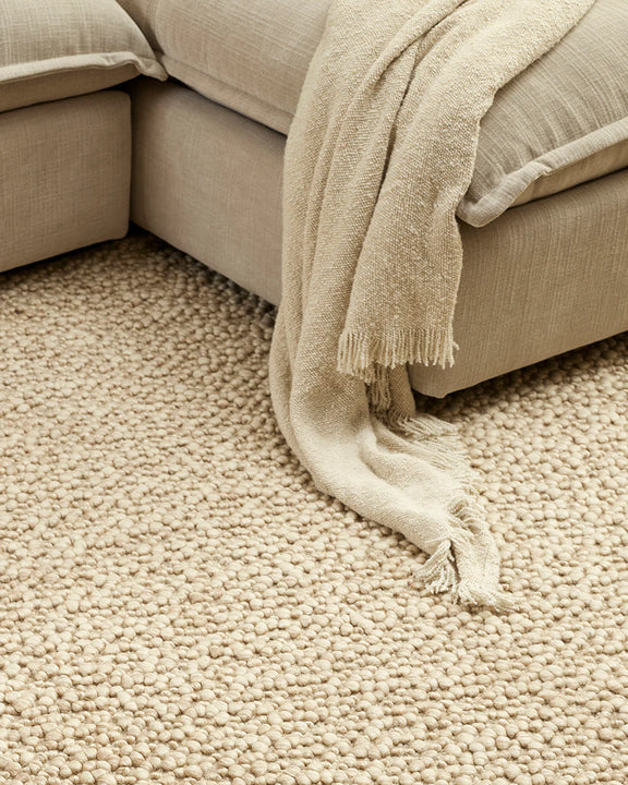 Neutral textured throw for sofa styling