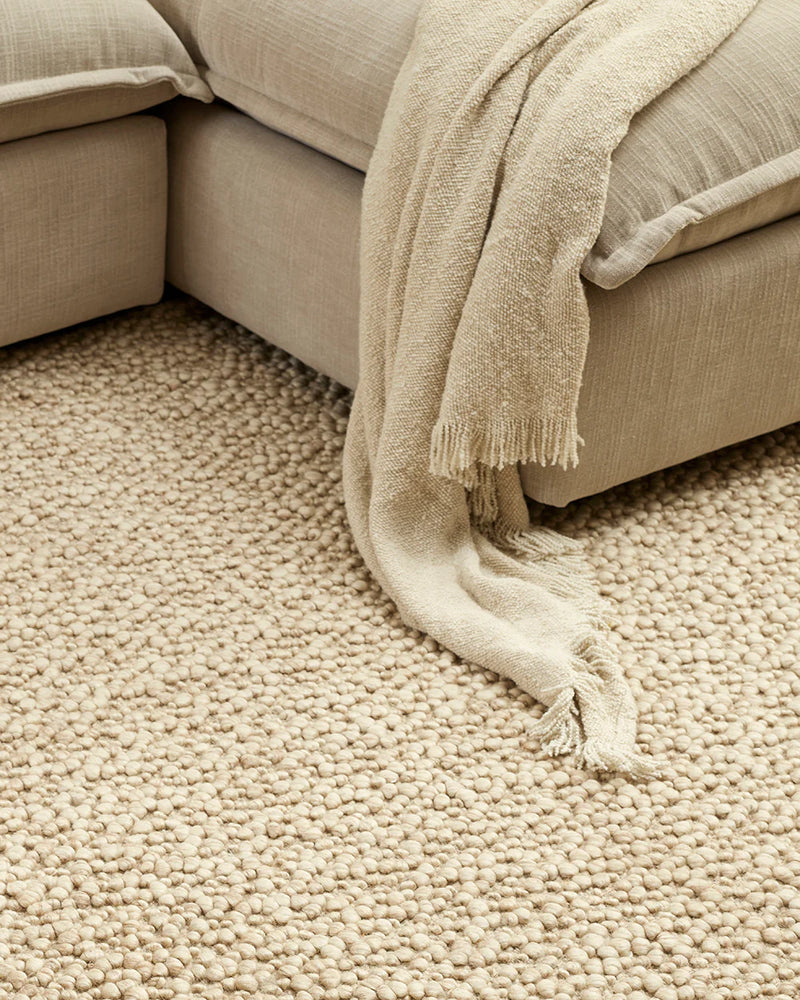 Neutral textured throw for sofa styling
