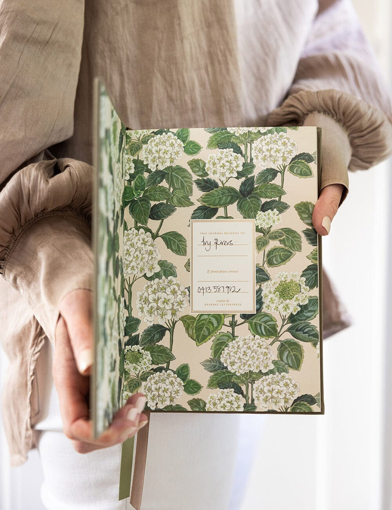 Premium fern green linen journal with bullet pages and satin ribbon markers.