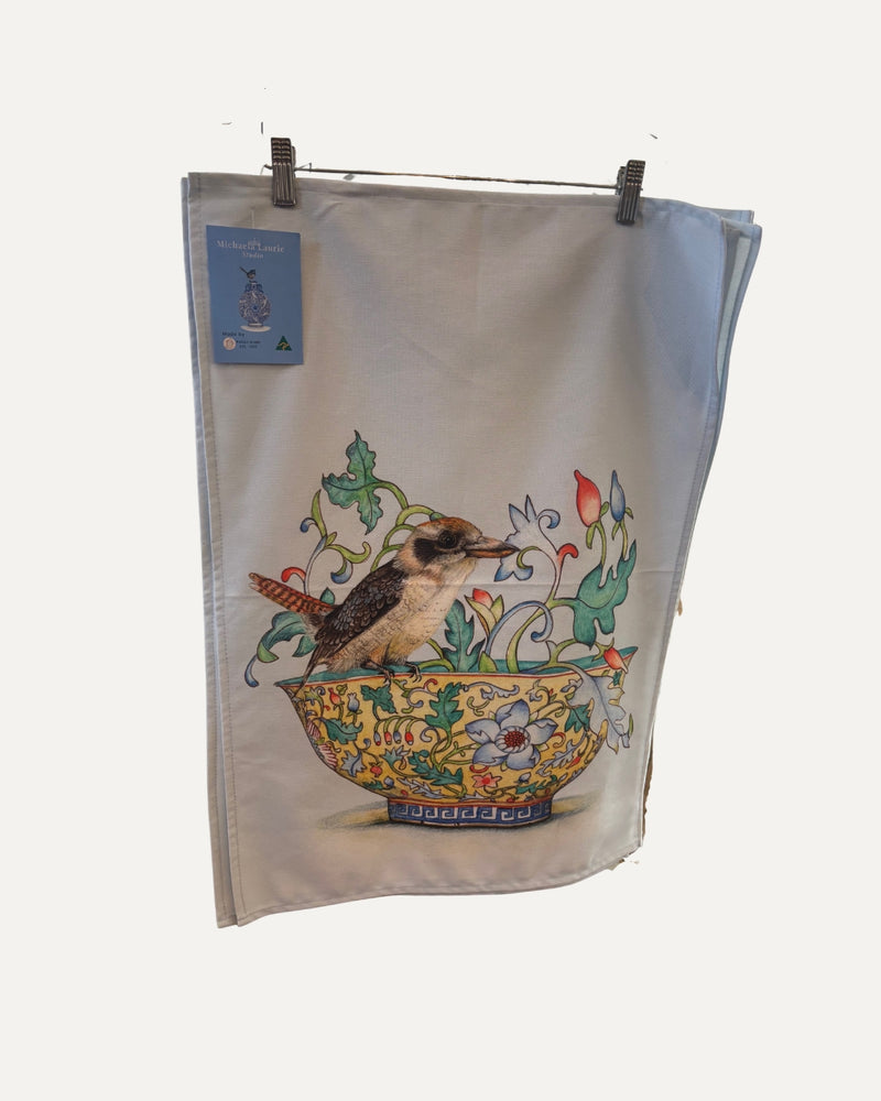 Australian made cotton tea towel featuring a kookaburra perched on a detailed floral bowl.