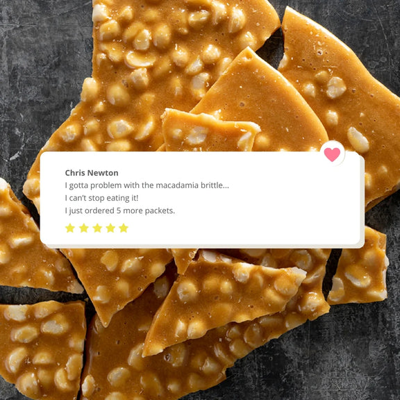 Macadamia brittle with a comment overlay on a dark background