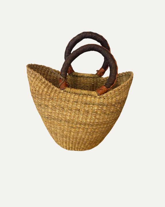 Mini natural woven market basket made from elephant grass with leather handle.