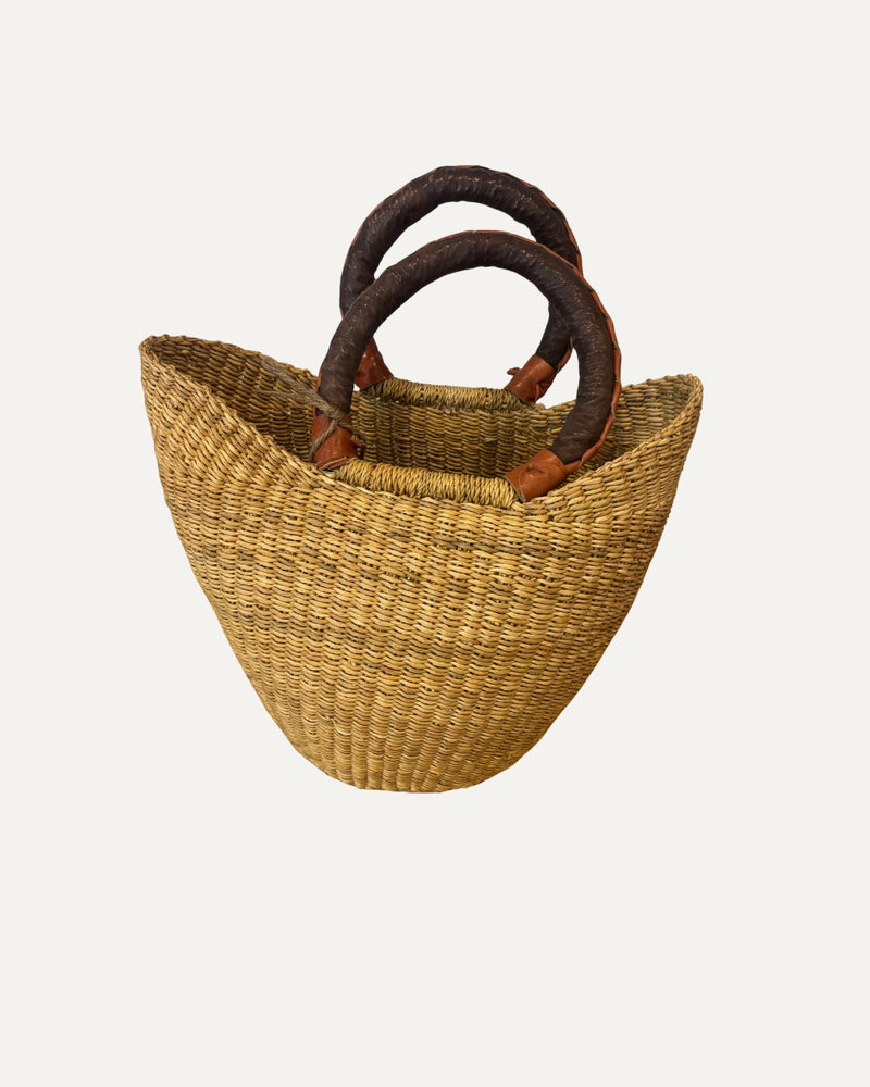 Mini natural woven market basket made from elephant grass with leather handle.