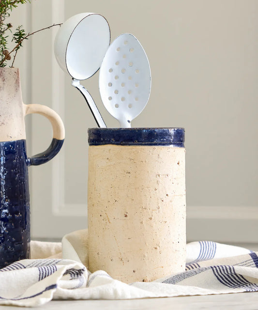 Artisan terracotta pot with rounded form and blue glaze