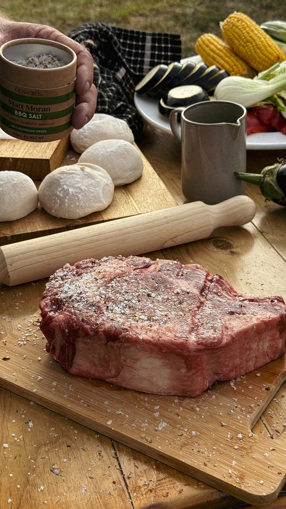 Olsson’s BBQ Salt styled beside grilled food on a BBQ table
