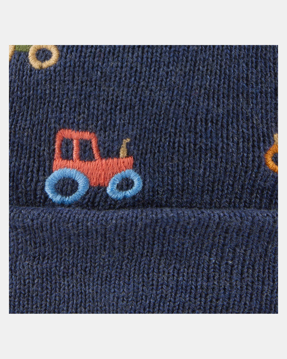 Navy blue fabric with a red and blue tractor design on a white background