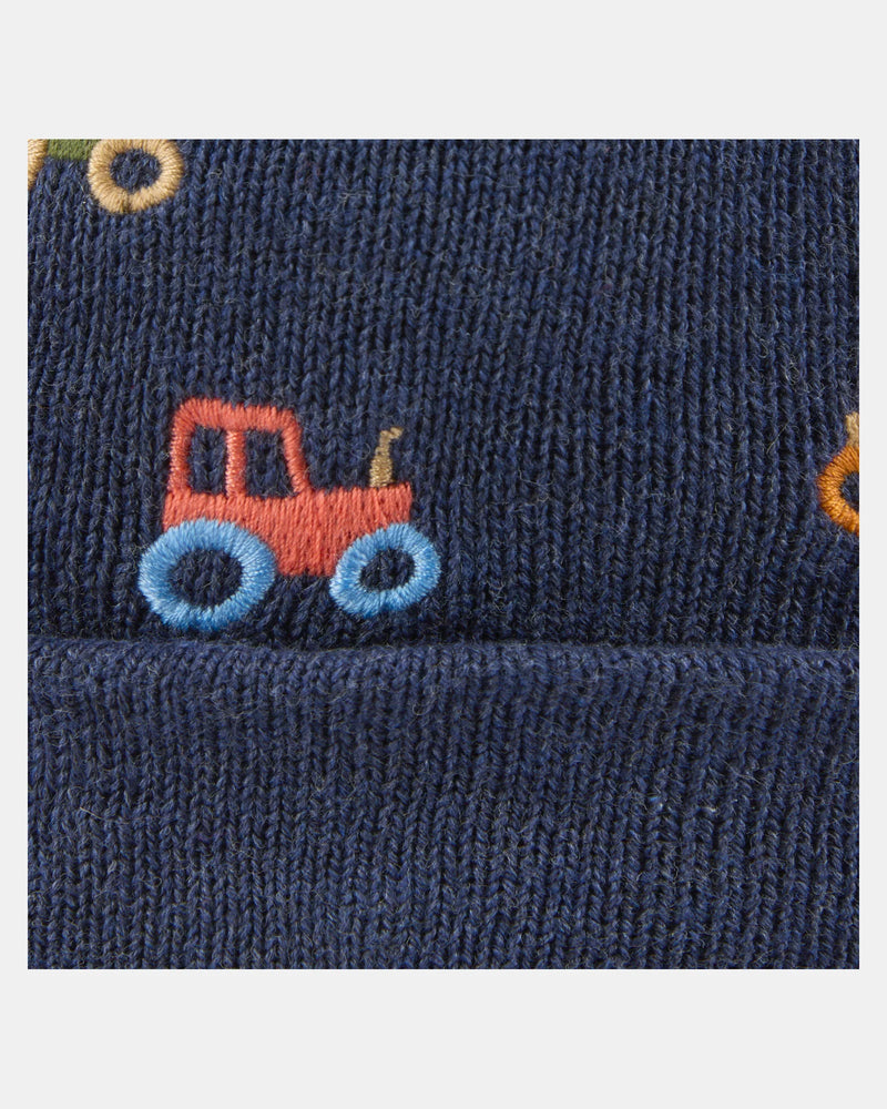 Navy blue fabric with a red and blue tractor design on a white background