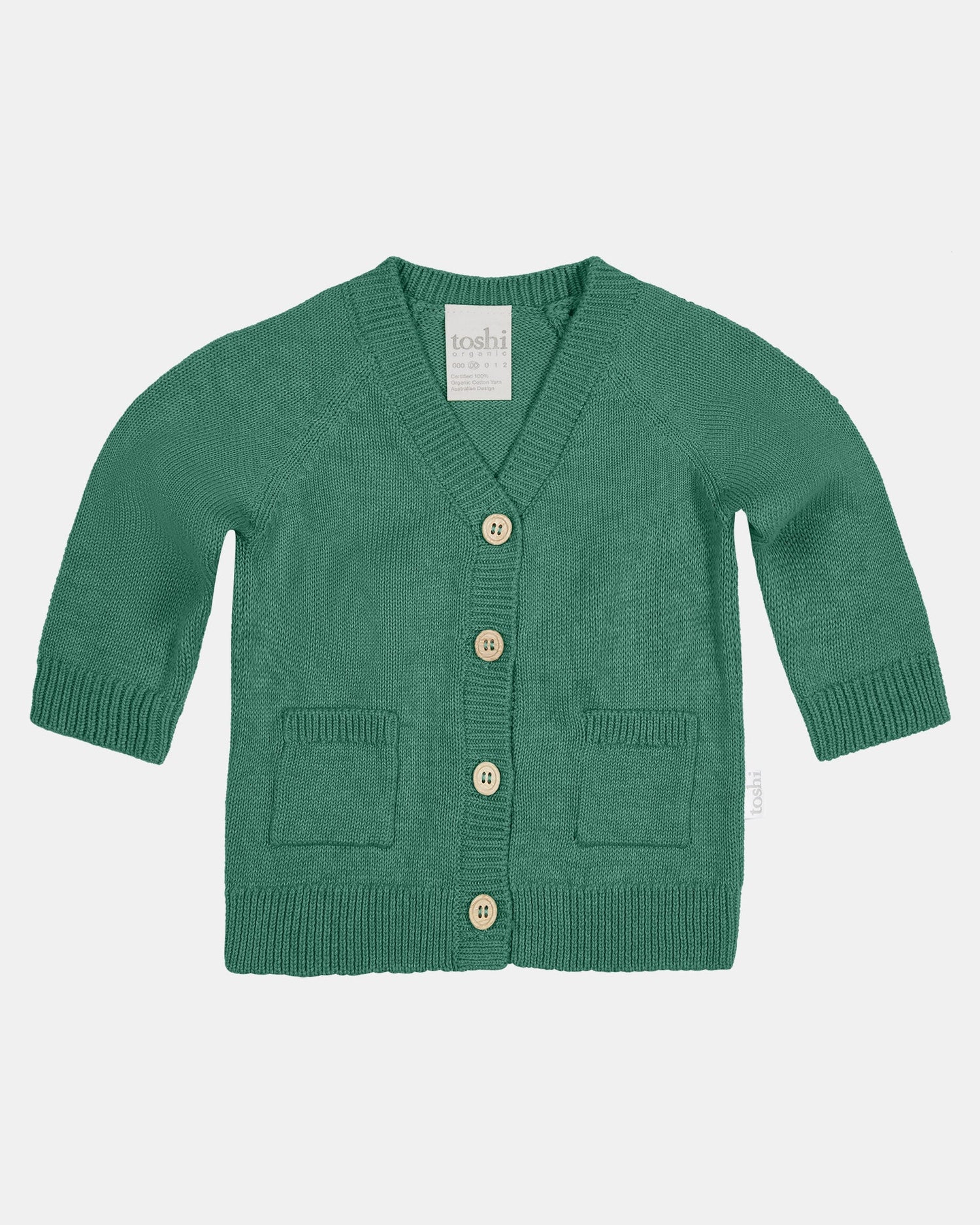 Green cardigan with button details on a white background