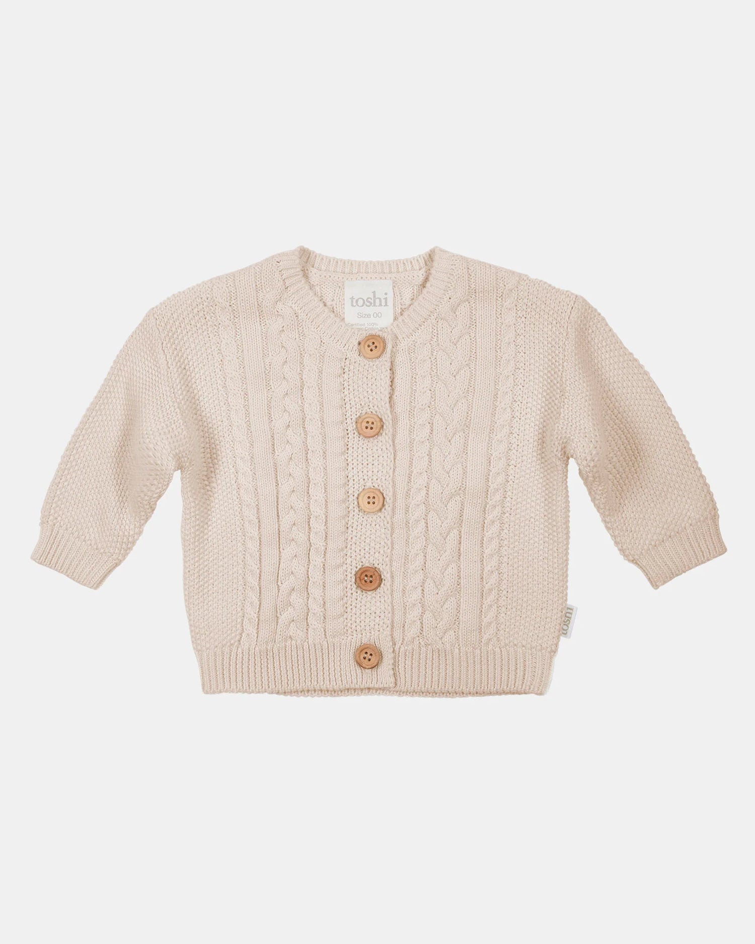 Beige baby cardigan with buttons on a light beige background