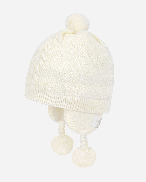 White knit baby hat with pom-poms on a mannequin head against a white background - available at My Country Escape Canungra and online