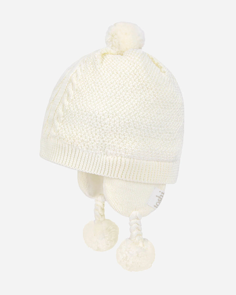 White knit baby hat with pom-poms on a mannequin head against a white background - available at My Country Escape Canungra and online