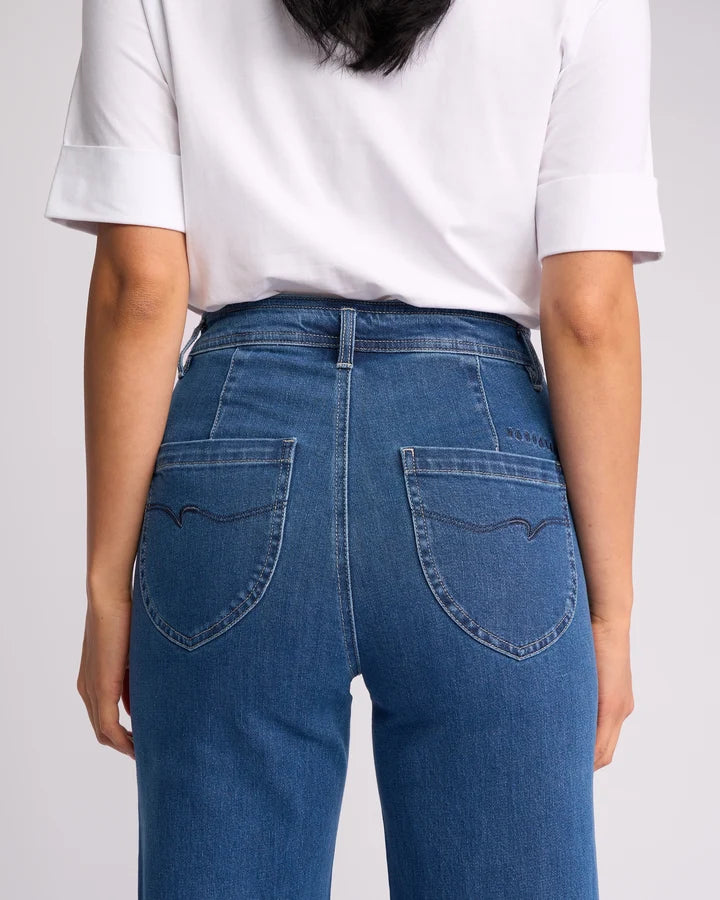 Person wearing blue jeans and a white t-shirt - Vassalli blue was denim peace jean