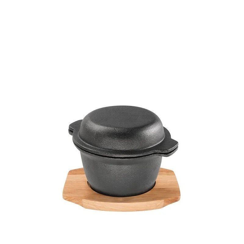 Black cast iron pot with wooden trivet on a white background. Pyrocast Garlic Pot W/Maple Tray. 