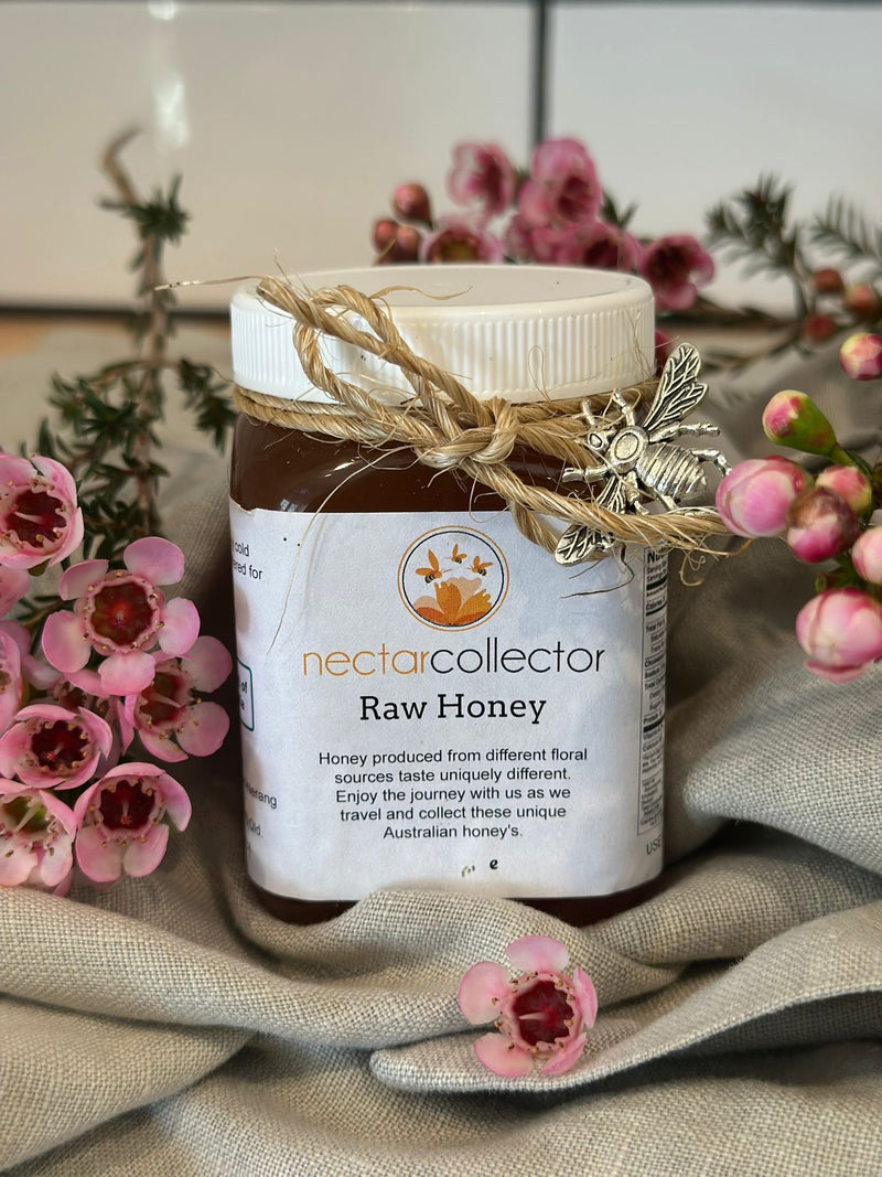 Jar of Nectar Collector Raw Honey with decorative elements on a floral background