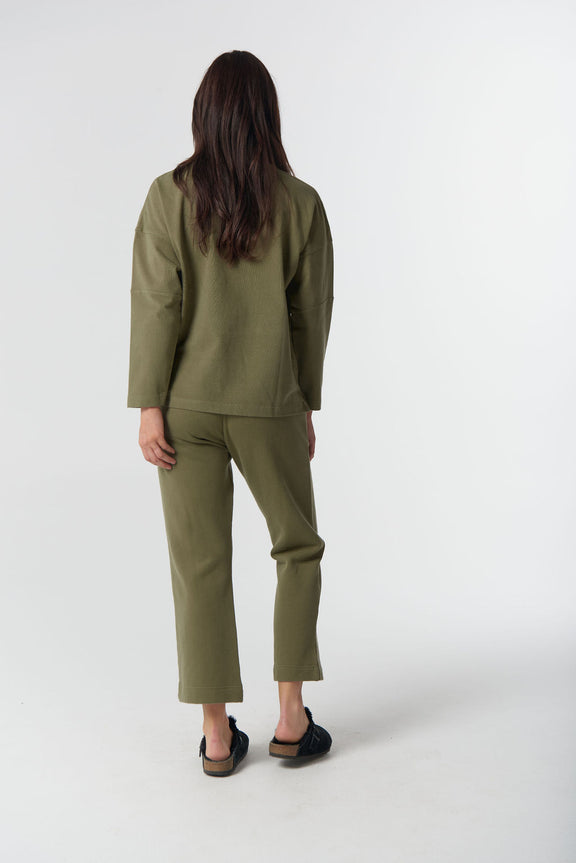 Women's sage green brushed cotton sweater with embroidered GC logo.