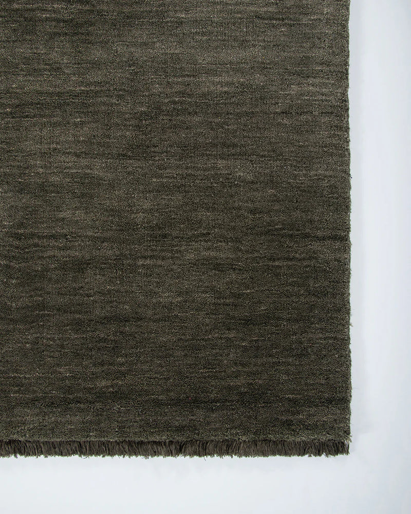 Dark gray textured rug on a white background