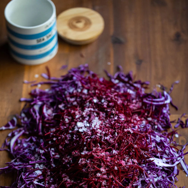 Olsson’s Sea Salt Flakes stoneware jar styled on a kitchen bench