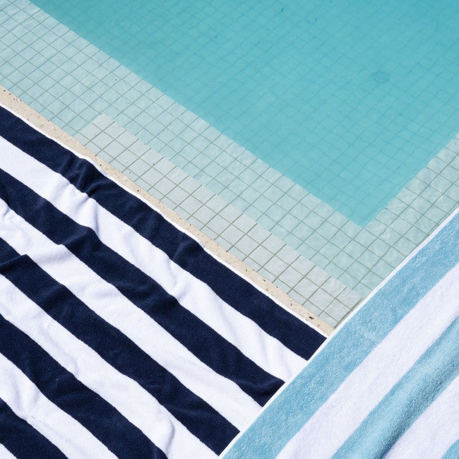 Classic navy beach towel by the water