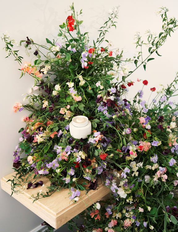 Floral arrangement surrounding an Ecoya Sweet Pea Jasmine Soy Wax Melt