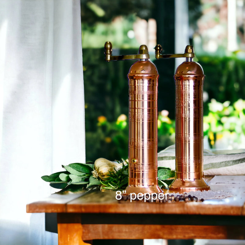 Premium copper pepper mill styled on a rustic table