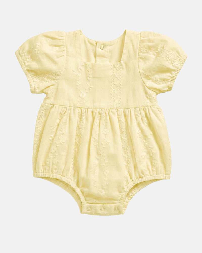 Toshi Baby Romper Florence Lemon in soft lemon yellow with embroidered fabric and puff sleeves.