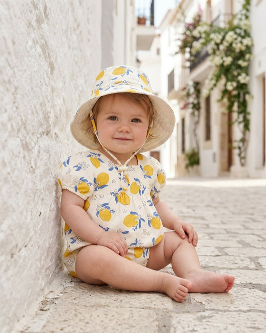 Baby cotton sun hat with adjustable toggle and safety-release chin strap by Toshi.