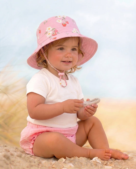 Children's cotton sun hat with adjustable toggle and safety-release chin strap by Toshi.