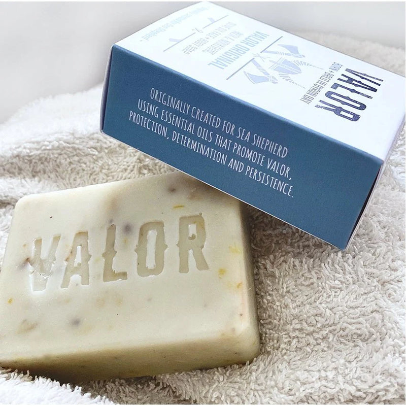 Bar of soap with 'VALOR' branding and a box on a textured surface