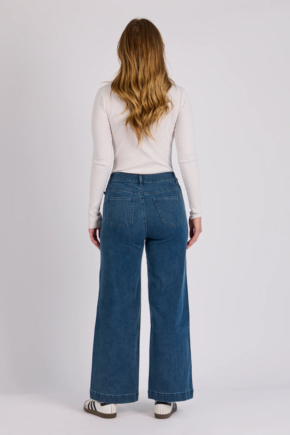 Mid blue cotton blend boyfriend jeans with cropped wide leg design for casual everyday wear.